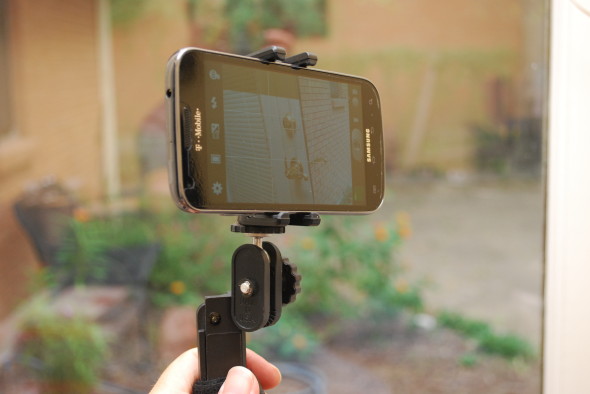 With an oblique view, you can see that the arms that hold the camera are rubberized, and they are deep enough to accommodate a camera in a case (I usually keep my camera better-protected, but wanted to simplify for this shot).